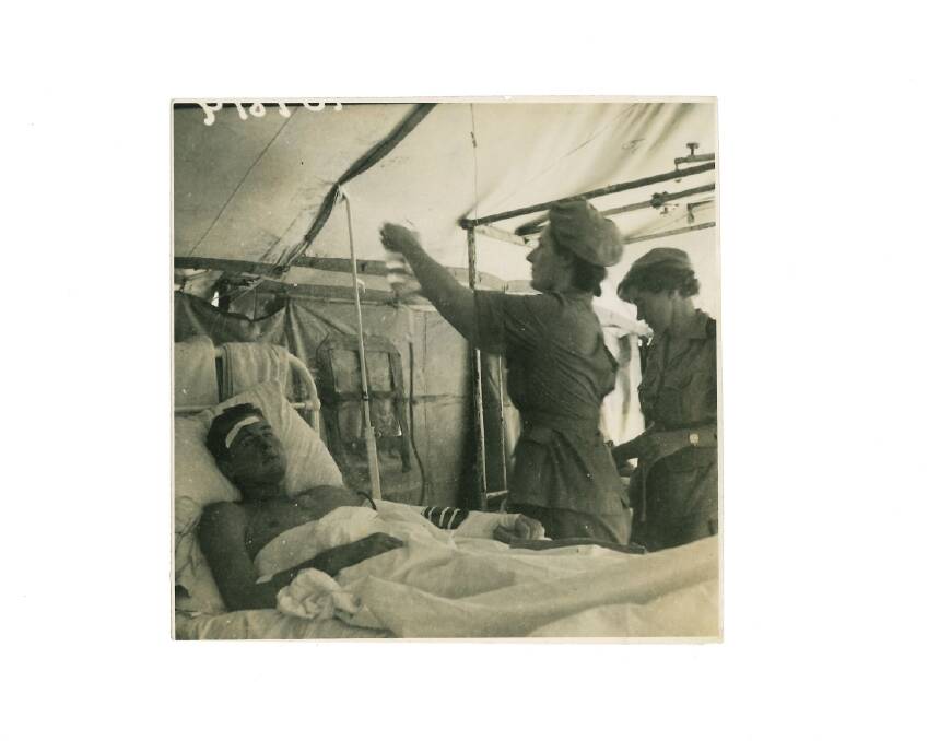 Edna's unit treats a wounded soldier on Moratai Island. Picture supplied by Brian Sherwood