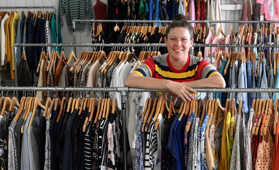 Store manager Emily Honess amongst racks of donated clothing, both second hand and vintage, that is sold at the Talking Threads store on Peel Street. Picture by Gareth Gardner