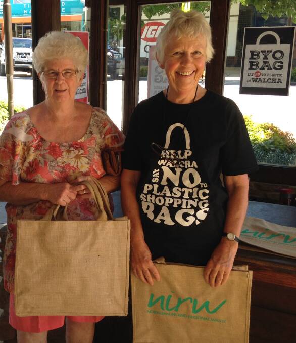 Local shopper Coral Westfold accepts a reusable hessian shopping bag from campaigner Caroly Laurie