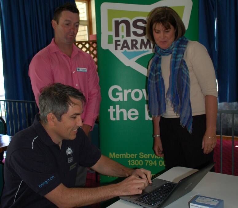 Getting Connected: NBN customer service representative Ian Scott shows the National Broadband Network roll out plan to Walcha councillor Clint Lyon and NSW Farmers Walcha chairperson Sonia O'Keefe on Wednesday.