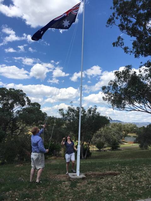 One for the family electorate: Barnaby and Nat Joyce raise the Australian flag on their Woolbrook property.