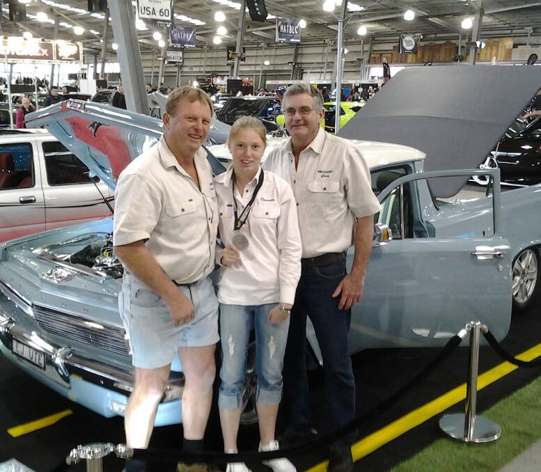 ONE FOR THE ROAD: Danny Hoy with daughter Danielle and mechanic Gary Dunn in front of 'Jasper' at MotorEx in Melbourne earlier this month. The Holden Commodore and 63EJute hybrid won silver for engineering.