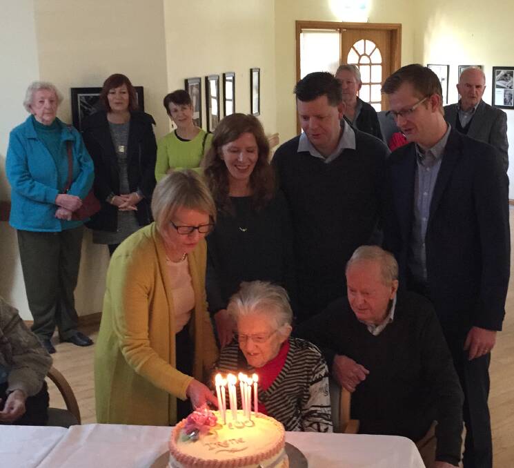 Happy birthday: Irene Hoy blows out her candles while her children, Margaret and Bevis, and grandchildren, Alicia, Stuart and Iain, watch.