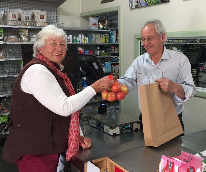 Plastic bag-free shopping: Cherie Pethard and Stephen McCoy, the owner of Think Naturally, trial one of the fruit and veg shop's new paper bags on Tuesday.