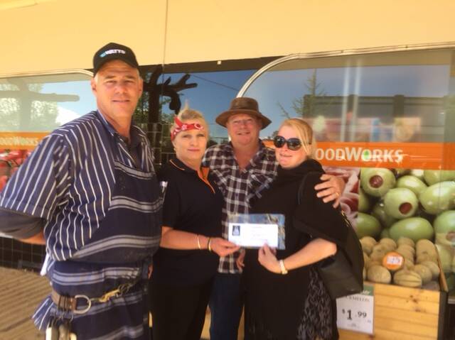 Mel and Adam Imberger receive their voucher from Foodworks owner Robert Watts and manager Jo Taylor.