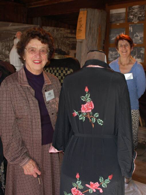 Bespoke beings: Walcha Historical Society member Jillian Oppenheimer with one of her grandmother's costumes and fellow member Nerida Hoy in the background
