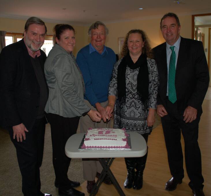 Presbyterian Aged Care CEO Paul Sadler with Riverview Hostel manager Olivia Wood, one of the original instigators Don Murchie, longest-serving employee Toni Brazel and Walcha Mayor Eric Noakes cut the celebration cake.