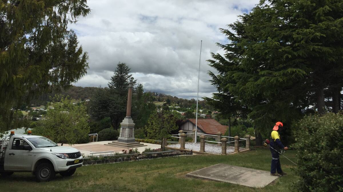 Walcha Council workers give the Walcha War Memorial a tidy up in readiness for the service on Saturday.
