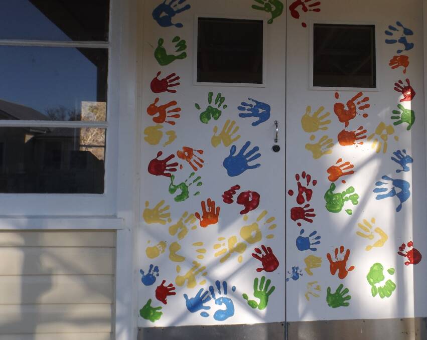 COLOURFUL: Students painted their hand prints on the craft room door.