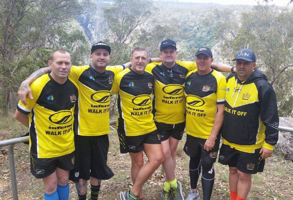 Team effort: The Walk It Off team stopping for a quick photo last week on their way to Walcha as part of a 916 kilometre trek to raise awareness for suicide prevention.