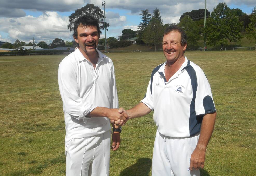 Top innings: Man of the match Steve Eveleigh is congratulated by his skipper Barry Hoy. 