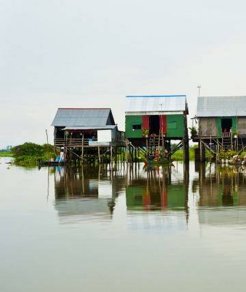 Charming coloured huts on stilts make up this picturesque floating village on Tonle Sap Lake. 