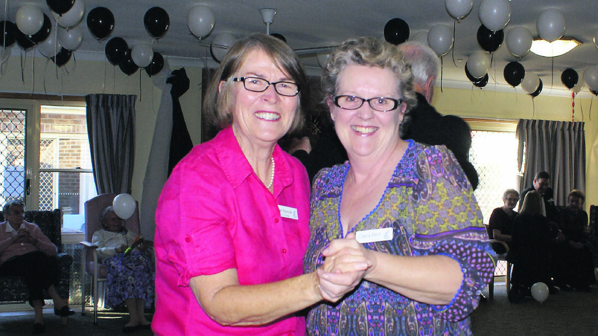 Lyn Burnell dances with Carol Bird at the recent Apsley Riverview masked ball.