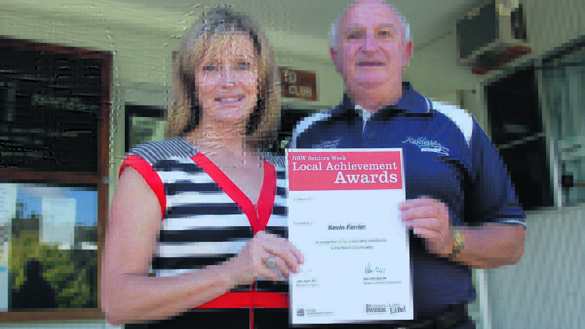 Walcha mayor Janelle Archdale presents Kevin Ferrier with his 2014 local achievement award.