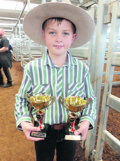 Iva Haling with the two trophies his family won at the Weaner Challenge at Tamworth last week.