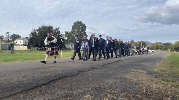 Bendemeer bagpiper John Murdoch led the servicemen and women in the march from the town centre across to the memorial by McDonald River. Picture by NDL
