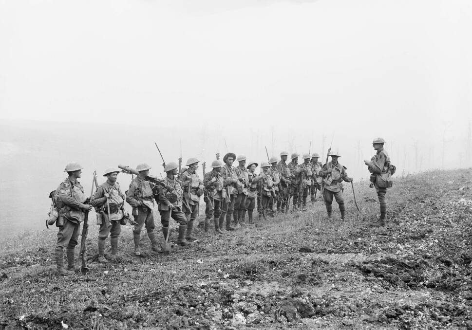 VITAL: Lieutenant Rupert Downes, an orchardist from Camden, addresses his platoon before the advance onto Harbonnieres during the Battle of Amiens. Picture: AWM E02790.