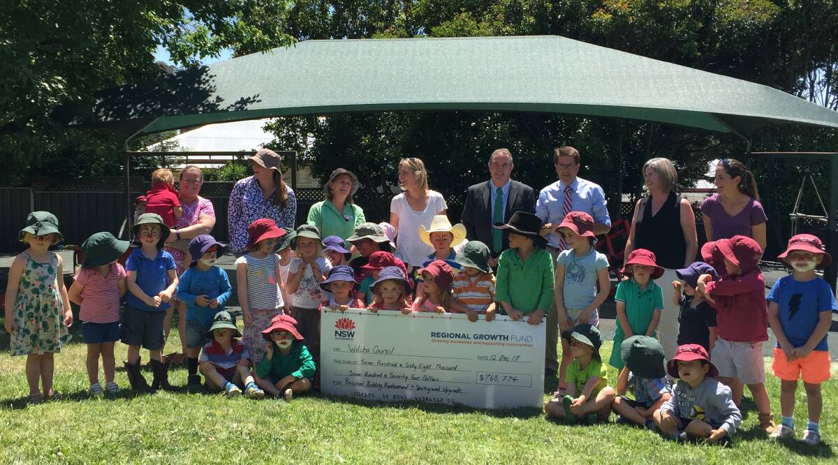 Happy New Year: Walcha Preschool students, parents and teachers hold the funding announcement cheque  with Walcha mayor Eric Noakes and  MP Kevin Anderson.