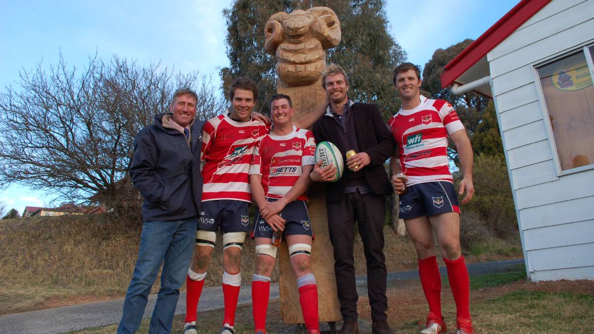 Walcha Rugby Club president Andrew Crawford stands in front of the newly installed ram sculpture with Henry King, Simon Newton, artist Ben Tooth and Will Fletcher.