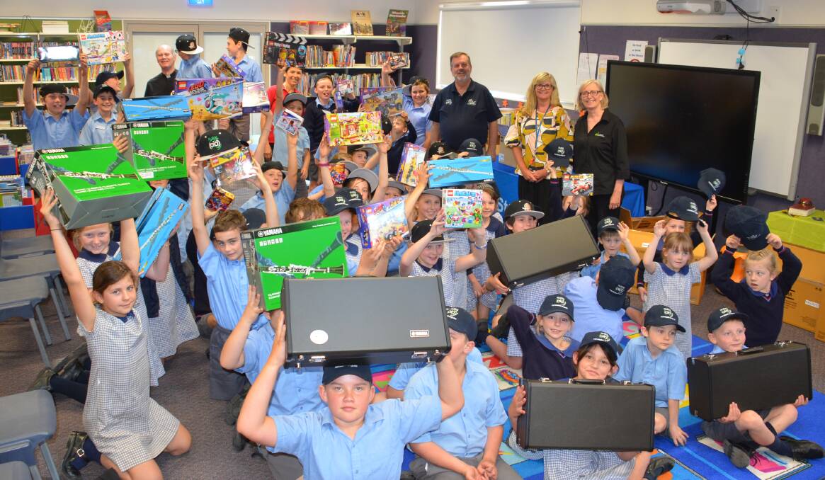 St Patrick's Walcha Principal Belinda Burton, staff and students with Gift of Music Rural Aid founders Wayne and Robyn Thomson and Monsignor Ted Wilkes.