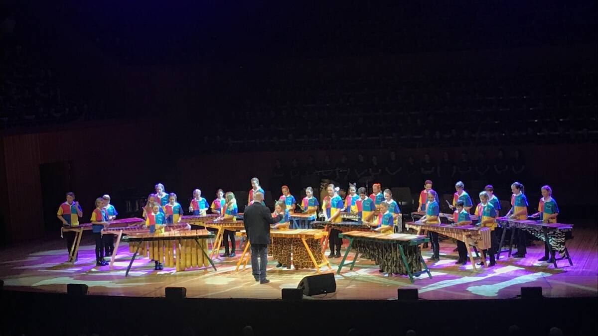 Kentucky Public School students on stage at the Sydney Opera House with the Combined State Small Schools Marimba and String Ensemble at the annual Choral Festival