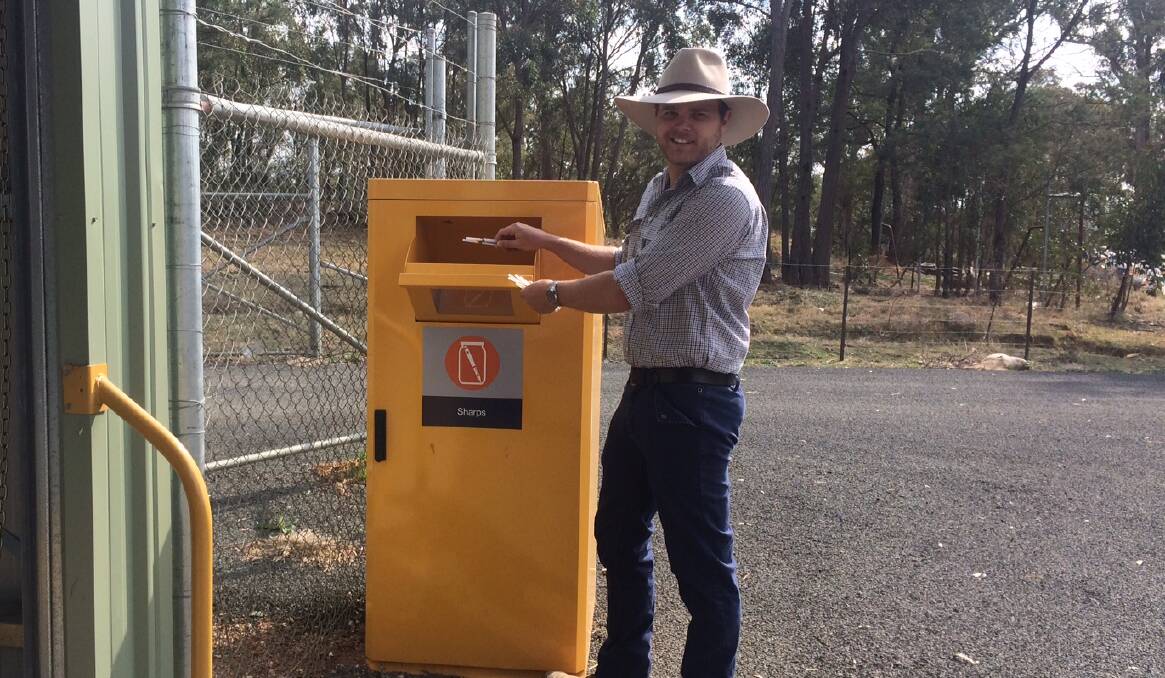 Luke Andrews with the new community sharps disposal bin.

