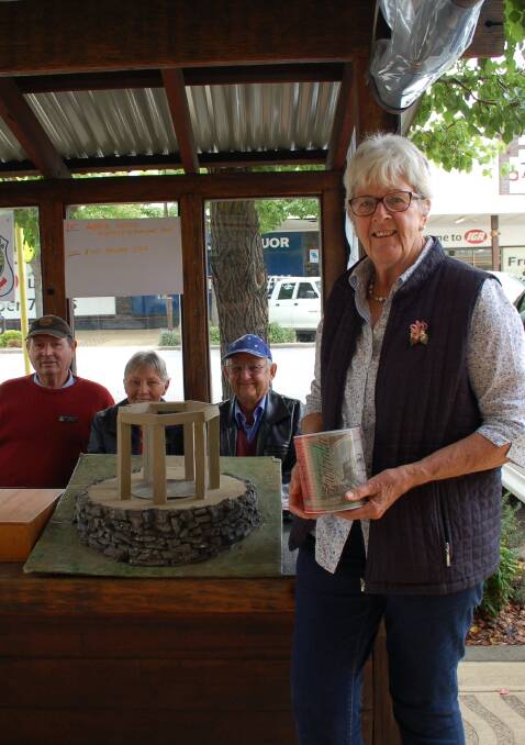 Tickets please: Walcha Returned Services League vice-president Liz Gill, with president Roy Westfold and treasurer Eric O'Keefe, holds a model of the proposed new monument  on the street stall last week. Photo: Vanessa Arundale