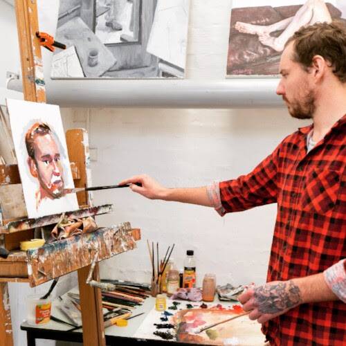 KEEPING IT REAL: James Needham at work on a portrait in his studio. He is enjoying producing landscape work en plein air during the Realm tour with Goldheist.