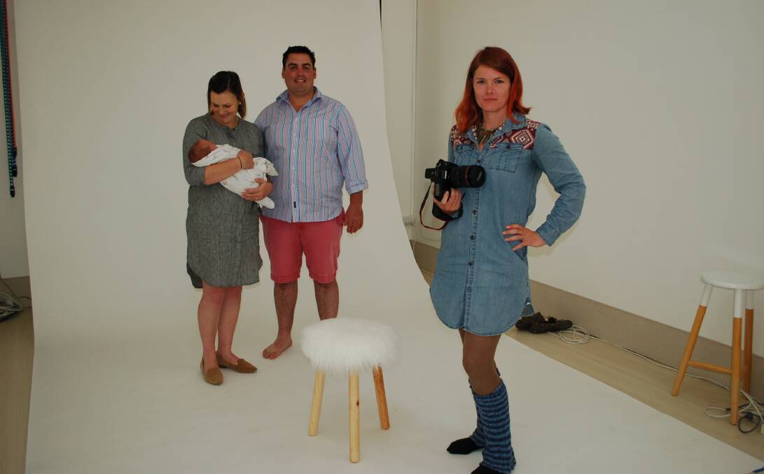 SMILE FOR THE CAMERA: Stef Cook in her recently opened Concentric Photography studio in Walcha on Wednesday, taking  family photos for Jodi and Samuel Martin to celebrate the birth of their son Max. Photo: Vanessa Arundale