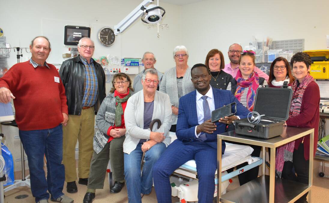 Dr Deng Abiem with Walcha Hospital Auxiliary president Phillipa Lawrence and members, Hospital manager Douglas Bellamy and Roy Westfold and Col Jenkins from Walcha Legacy