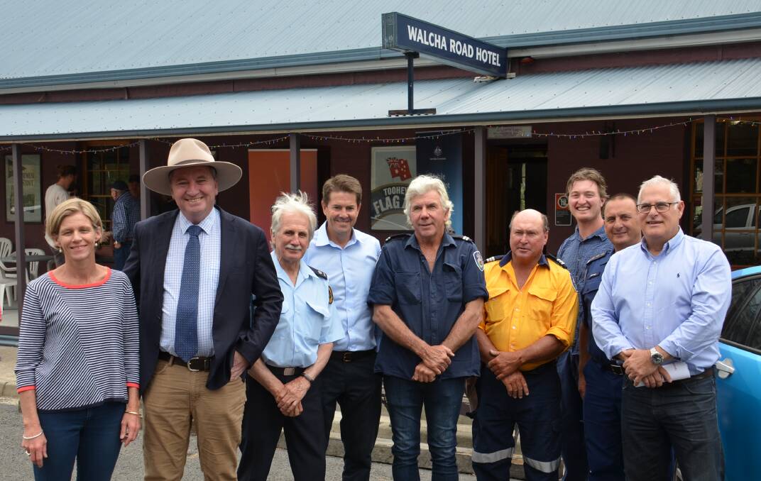 Parliamentary secretary for Regional Roads, Maritime and Transport and Member for Tamworth Kevin Anderson MP, with Member for New England Barnaby Joyce MP and Telstra Area general manager Mike Marom chat with Walcha councillor Jen Kealey and local Emergency Services staff at Walcha Road yesterday