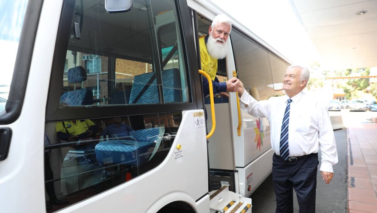 THE WHEELS ON THE BUS: Walcha Council OH&S officer Noel O'Brien gets the bus keys from Blacktown mayor Tony Bleasdale on Tuesday