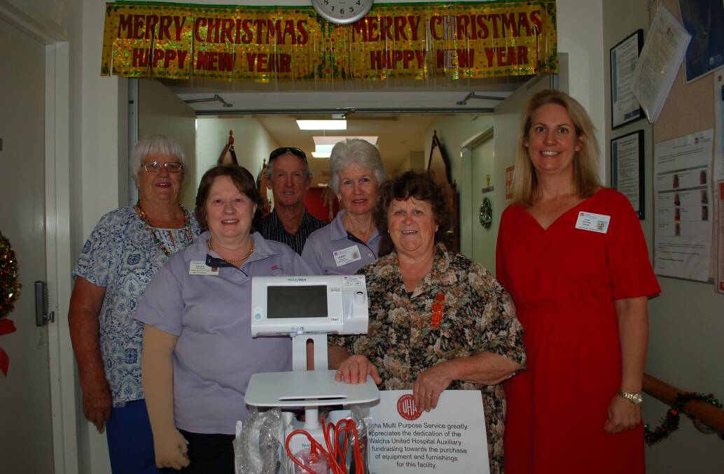 Members of the Walcha MPS Hospital Auxiliary: Sandra Partridge, Kerry Hollis, Brenda Walker, Peter and Vicki McIvor with HNEH Peel manager Kylie Whitford and the mobile observation trolley and appreciation certificate.