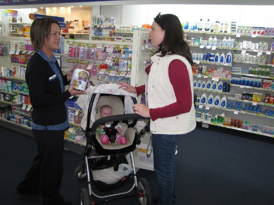 VITAL HELP: Ali Greenhalgh on the job, helping a new mum with a purchase.