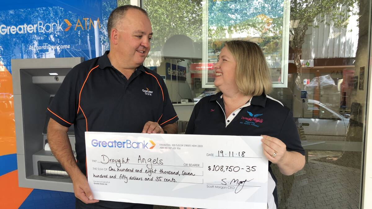 Greater Bank’s group executive of sales marketing & distribution, Craig Newham hands over the cheque to the co-founder and director of Drought Angels, Tash Johnston.