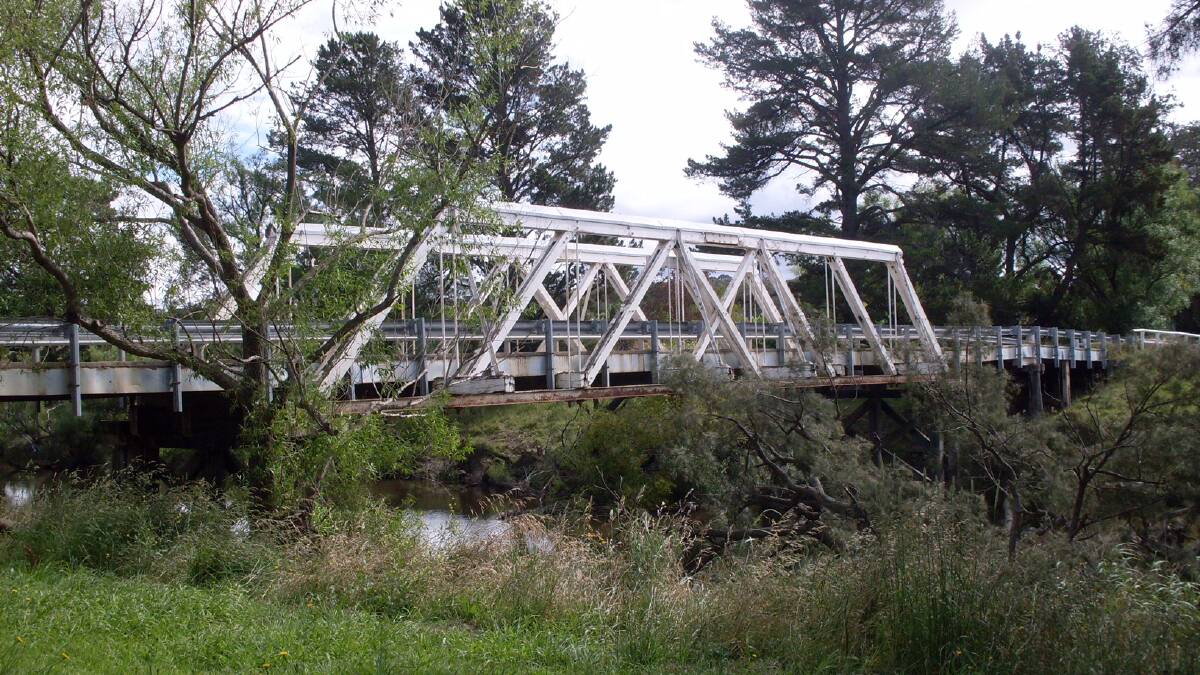 Macdonald River crossing: A 2010 photo of the truss and beam road bridge across the Macdonald River at Woolbrook. It has since been replaced by a concrete bridge.