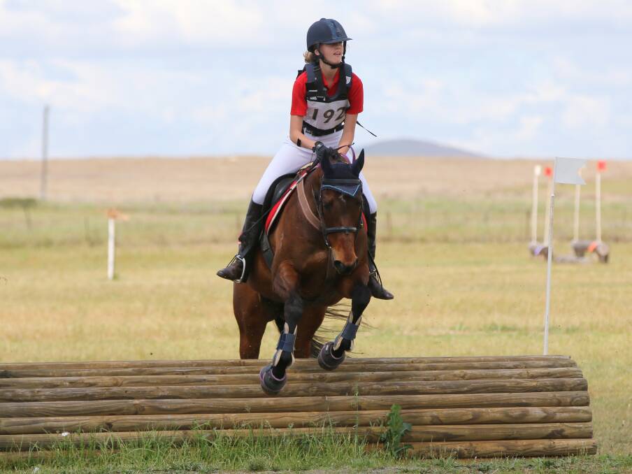 SOARING: Charlize Haling looks for the next jump in the cross country phase of the one day event. 