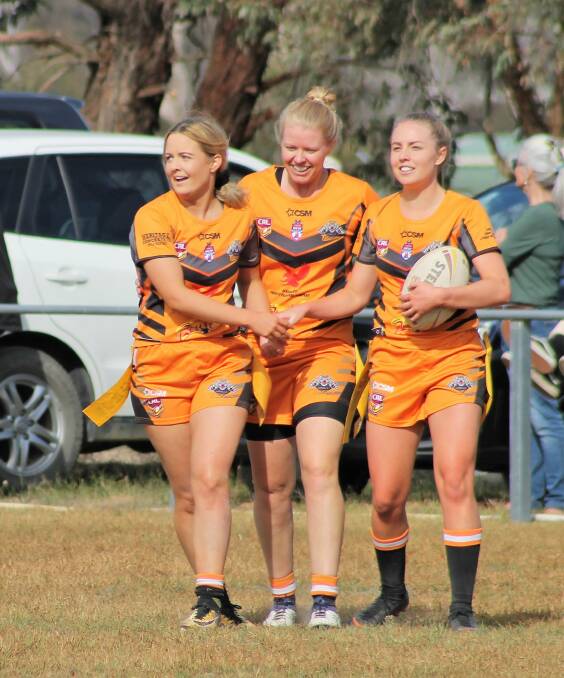 TOP SPOT: Uralla captain-coach Alyce Walsh, Camilla Clydsdale and Sophie Barraclough celebrate a try on Saturday. Photo: Uralla Tigers. 