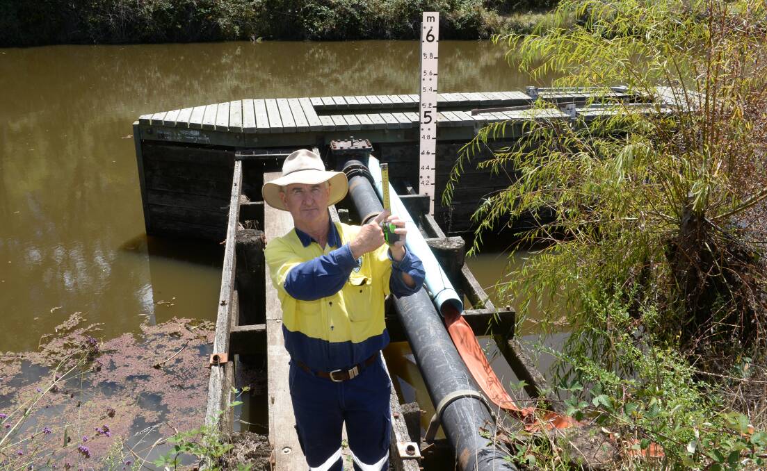 Walcha council's water and sewer supervisor Kevin Creighton shows how far it is on a tape measure before Walcha's town water system runs dry from its source at the Macdonald river.