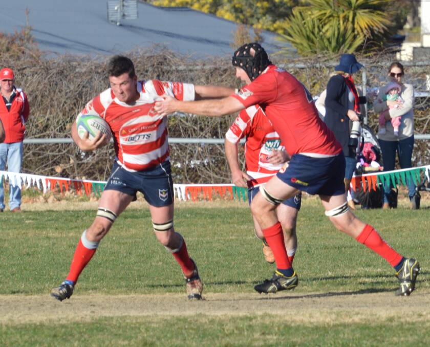 Captain courageous: Walcha skipper Will Fletcher looks to give Gunnedah's Matt Roseby the brush-off during last week's preliminary final win. On Saturday he'll lead the Rams onto the grand final stage.
