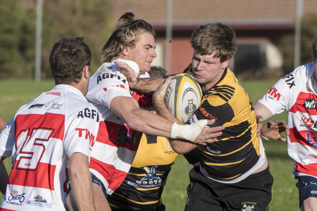Walcha centre Pat Keen attempts to wrap up Pirates winger Sam Bowden during their second round clash. Photo: Peter Hardin
