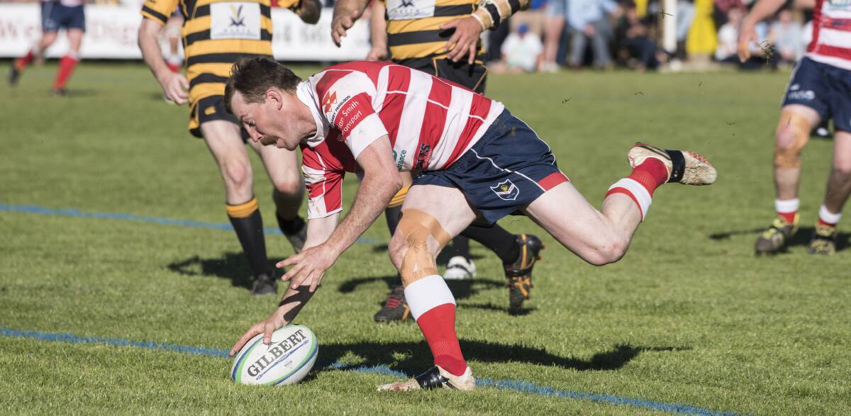 Try-time: Ed Churchill plants the ball down for Walcha's second try and the first of his hat-trick. Photo: Peter Hardin