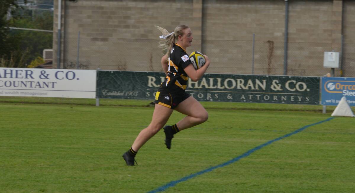 Lauren Daye streaks away for the first of her two tries. 