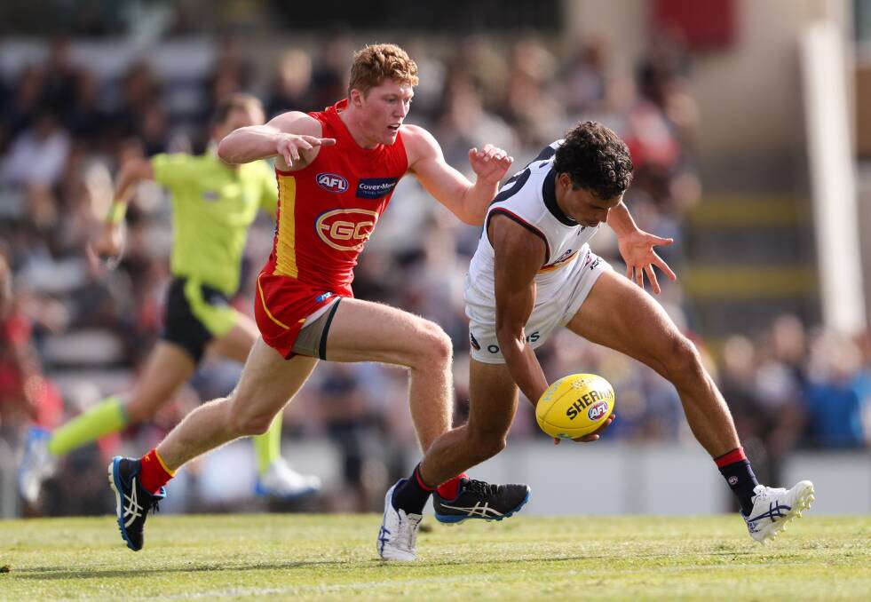 The Gold Coast Suns' Matthew Rowell chases the Crow's Ben Davis during a match earlier this year. A reader suggests no player has had a better start to an AFL career than Rowell. Unfortunately he suffered a shoulder injury against Geelong last weekend. Photo: Getty Images
