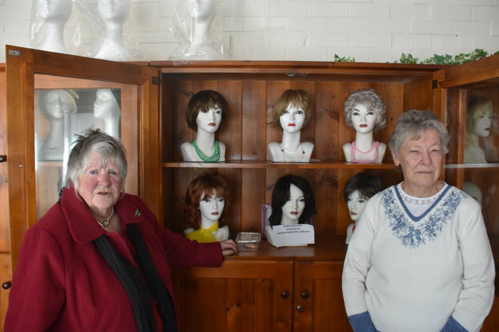 WIG LIBRARIANS: New England Wigs and Headwear Library secretary Jan Day and committee member Gwen Hodgson, with some of the wigs. Photo: Nicholas Fuller