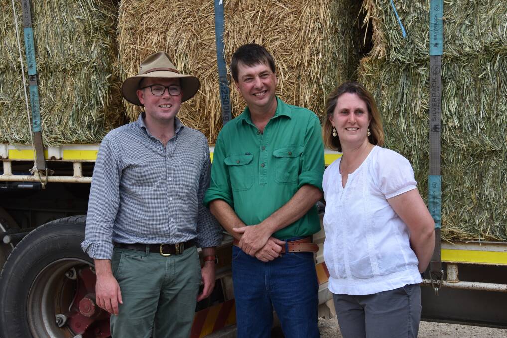 WELCOME RELIEF: Northern Tablelands MP Adam Marshall with Guyra farmers Matthew and Jenny Friend in front of the B-double fodder donation. Picture: Nicholas Fuller