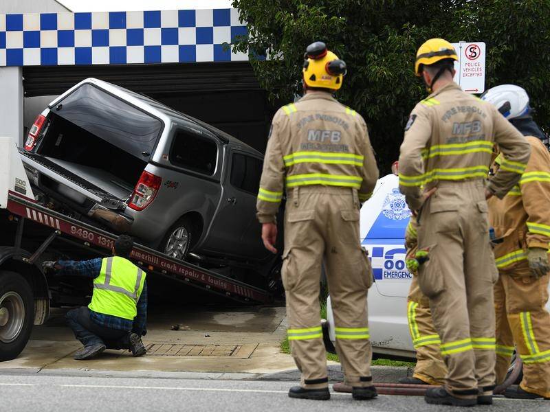 A man is in custody after crashing a 4WD through the garage door of a Melbourne police station.