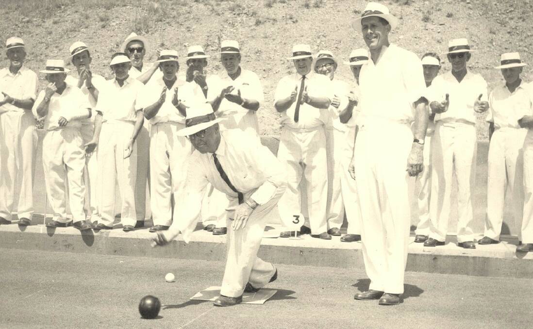 Smooth release: Club patron WM “Doc” Lonergan bowls the “first” ball at the 1966 opening of the club’s second green with Fred Roper standing close by.