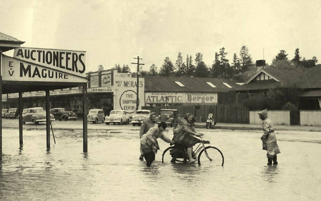 Heavy weather: Trouble with a pushbike in the Fitzroy Street floodwaters of August 1952.