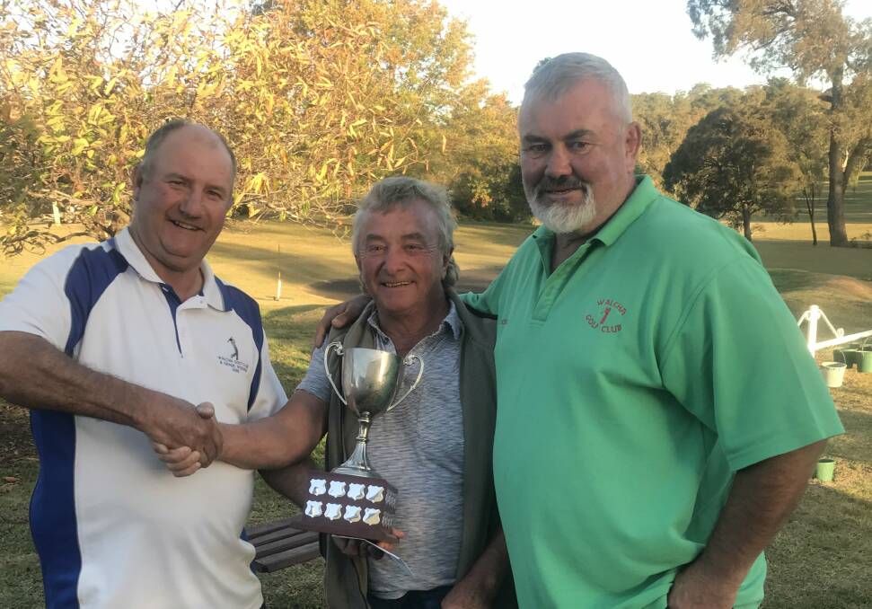 Swingers: Club captain Willy Brennan presents Molleydookers Mal Ballard and A.J.Cross with their prize.